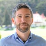 Photo of Joe Speicher in a light blue button up shirt
